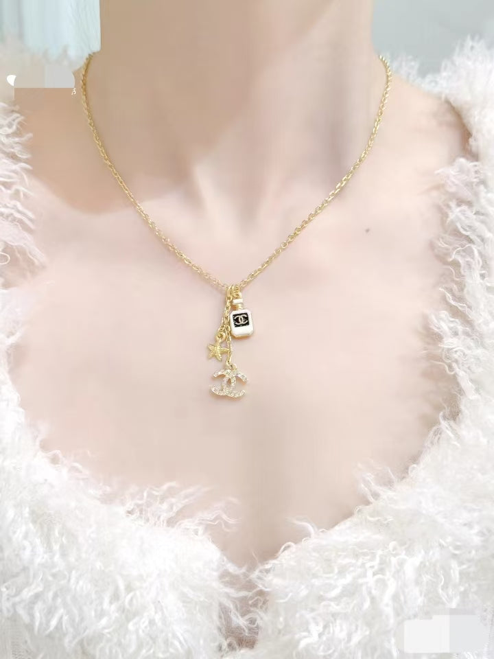 Gold Tone Multi-Charm Long Sweater Necklace, Perfume Bottle & Starfish Pendants