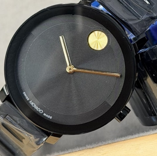 34 mm black watch with gold hands