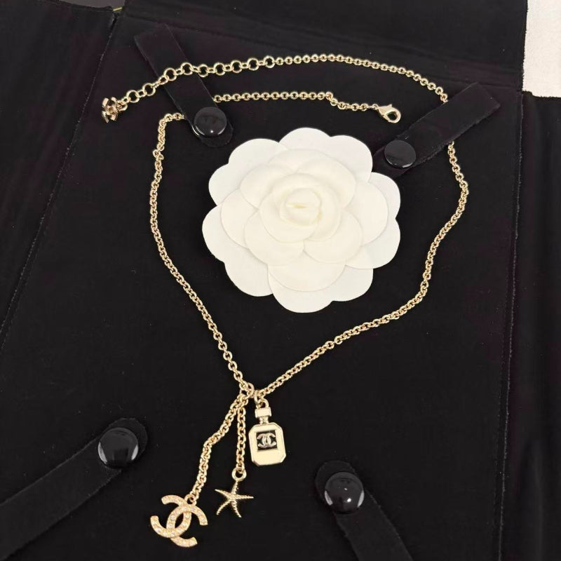 Gold Tone Multi-Charm Long Sweater Necklace, Perfume Bottle & Starfish Pendants
