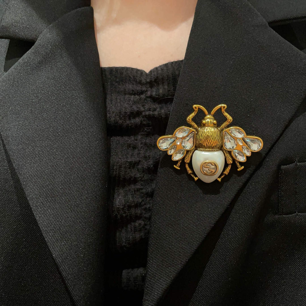 Broche abeille aux ailes facettées et détail en perle
