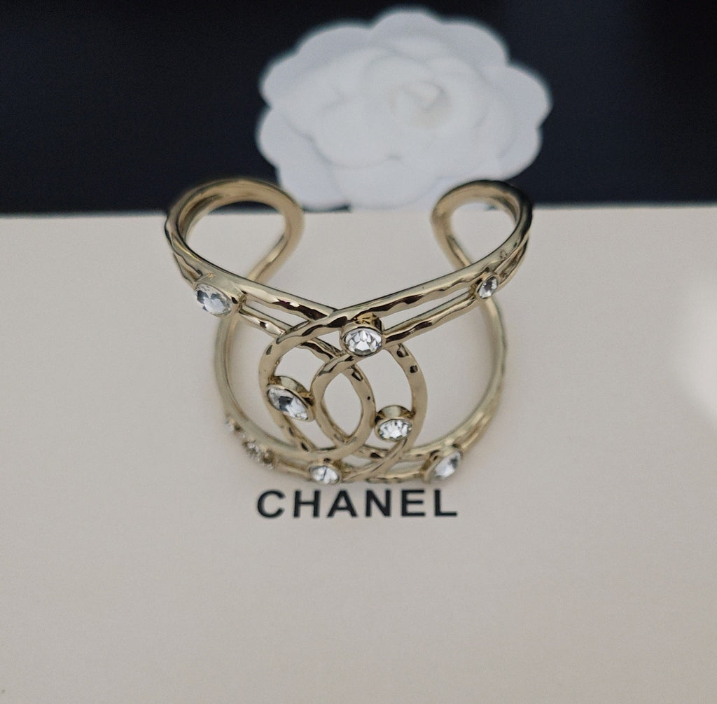 Pulsera rígida entrelazada con detalles de piedra