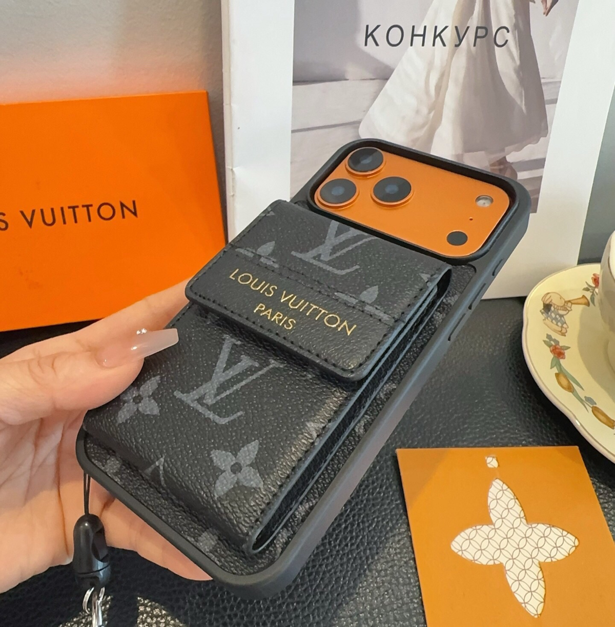 Black monogram phone case with flap card pocket and wrist strap, detail 3