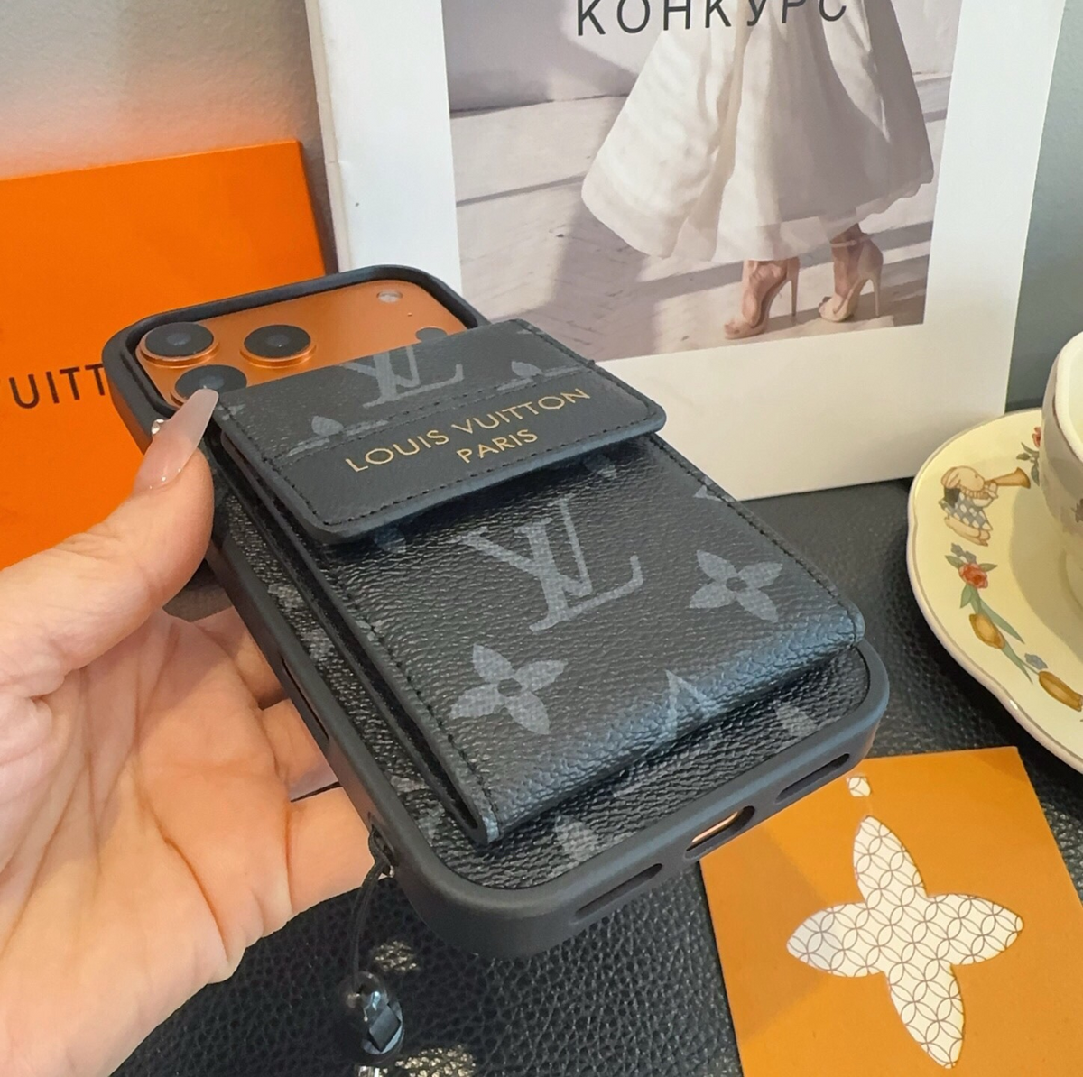 Black monogram phone case with flap card pocket and wrist strap, detail 4